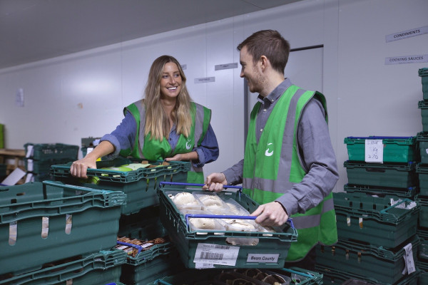 Two volunteers with donation trays