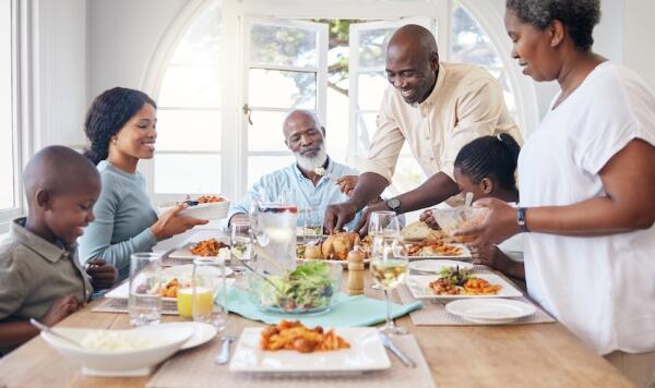 Family enjoying a meal of chicken around the table