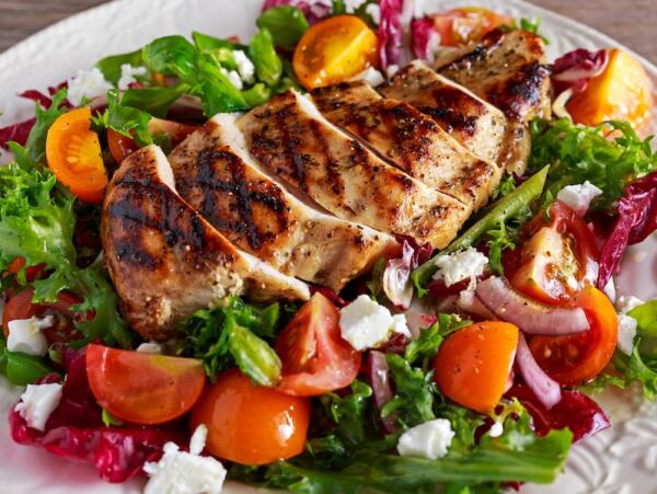 Grilled chicken over a salad